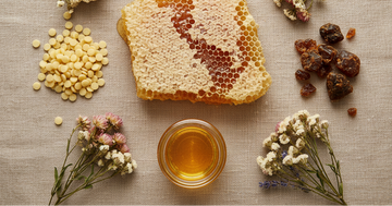 Flat lay of natural hive skincare ingredients including honeycomb, beeswax, and propolis